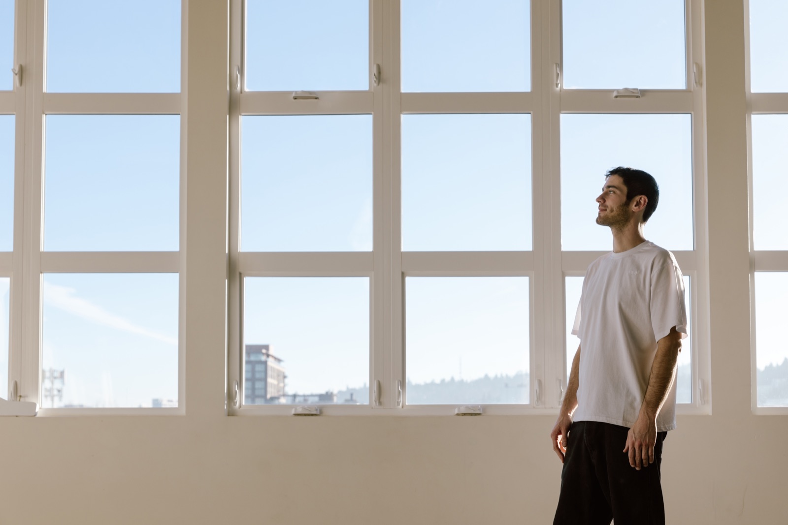 Dan Gomez standing beside a sunlit window
